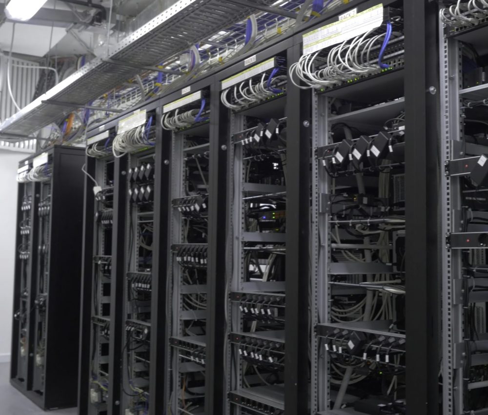 Row of bitcoin miners set up on the wired shelfs. Device for mining crypto currency. Mining cryptocurrency. Bitcoin farm. Machines for mining cryptocurrency, bitcoin. Electronic device at day 4K